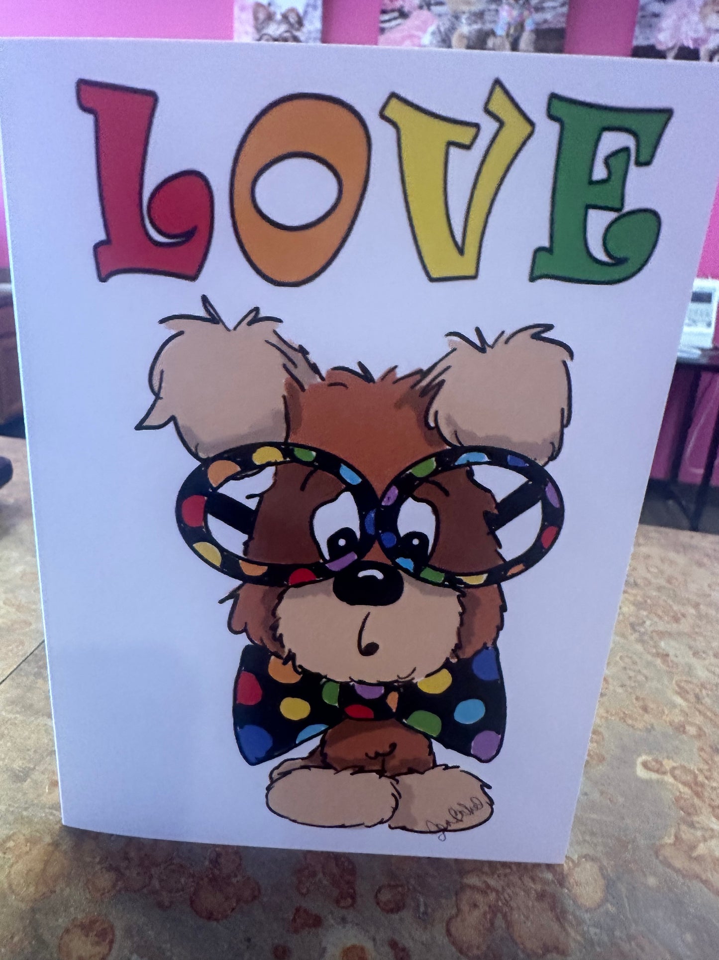Brown doggie w rainbow bow tie n glasses. Love collection